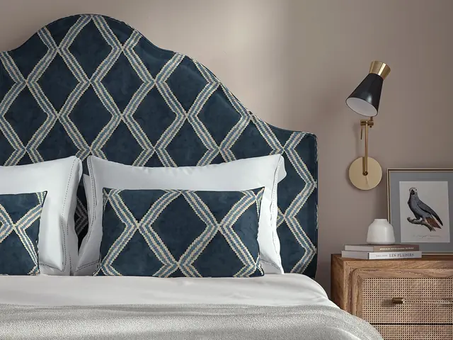 Upholstered headboard and cushions in dark blue geometric fabric