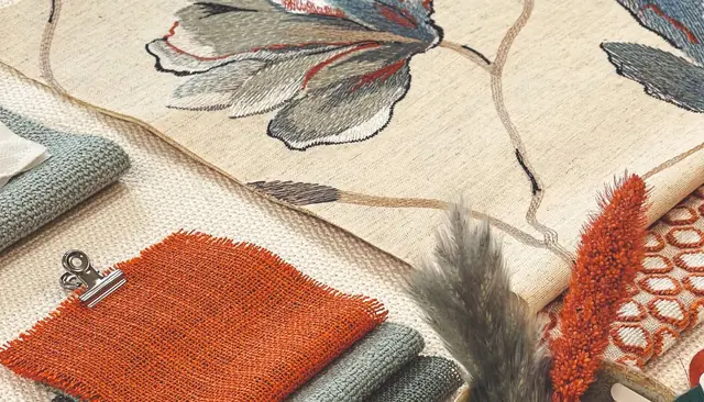 Designer fabric samples showing embroidered floral, woven and textured fabrics