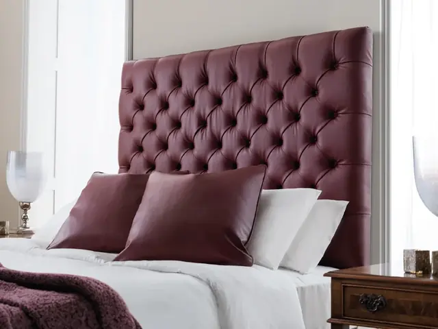 Deep buttoned upholstered headboard in burgundy fabric