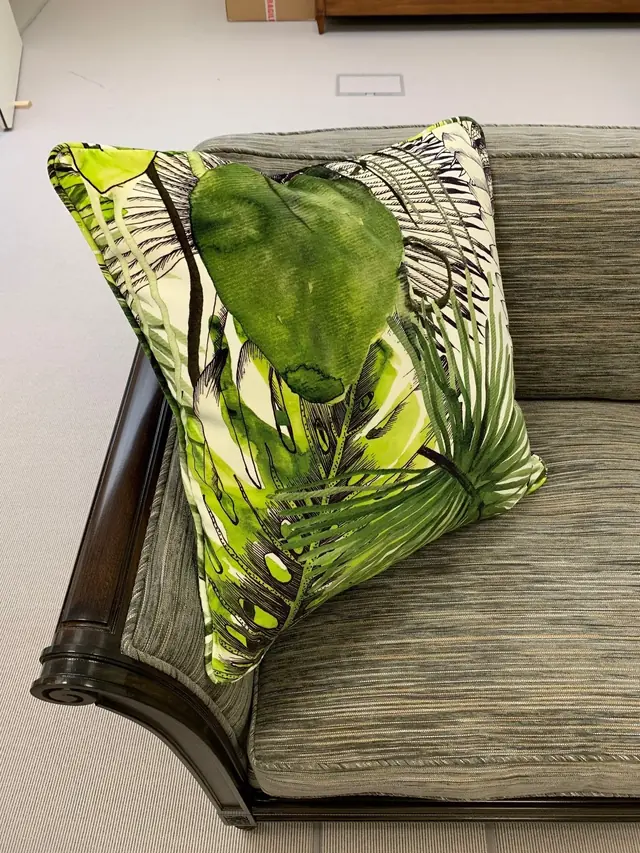 Bespoke green botanical patterned cushion with piped edge