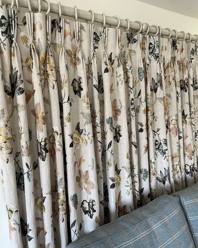 Pleated floral curtains made by TM Interiors on a decorative curtain pole