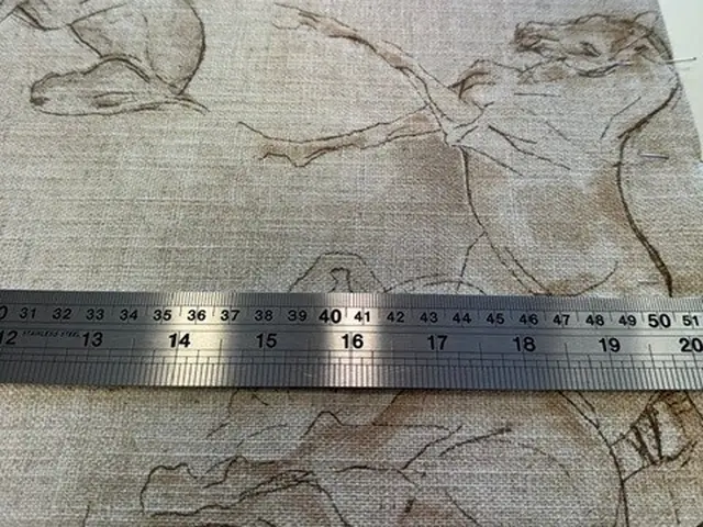 Patterned fabric being measured for a Roman blind in the TM Interiors workroom