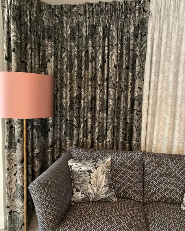 TM Interiors showroom curtains in a monochrome botanical fabric with coordinating sofa and cushion