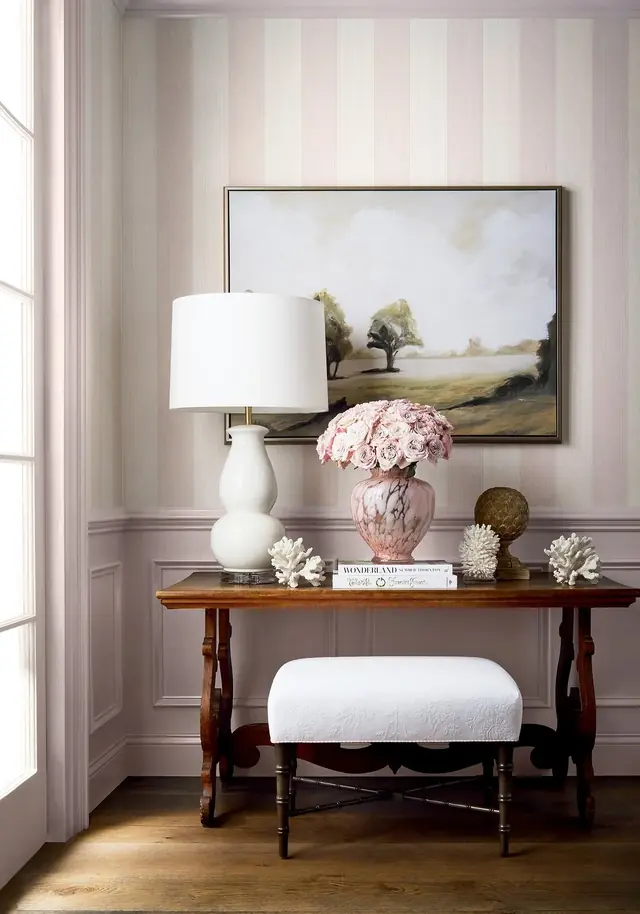 Soft blush pink striped wallpaper in a light interior