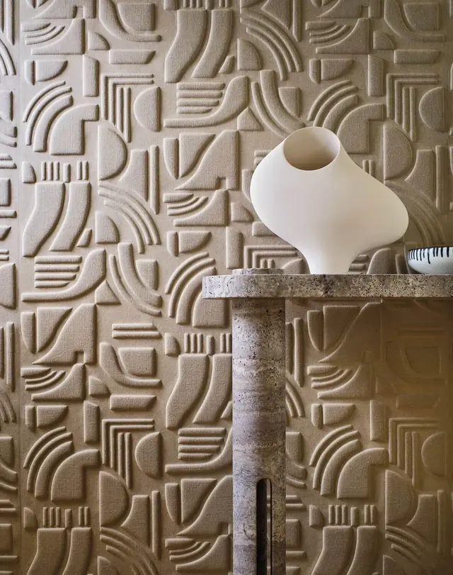 Neutral sculptural wallcovering showing raised geometric texture and dimensional surface