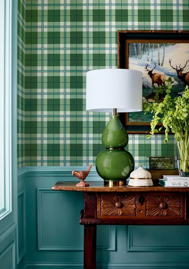 Green Thibaut tartan check wallpaper in a traditional interior with timber furniture