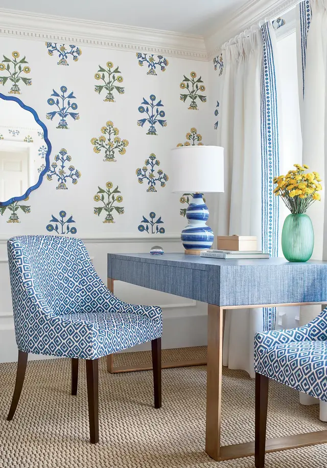 Traditional blue floral motifs arranged across white wallpaper in an elegant interior