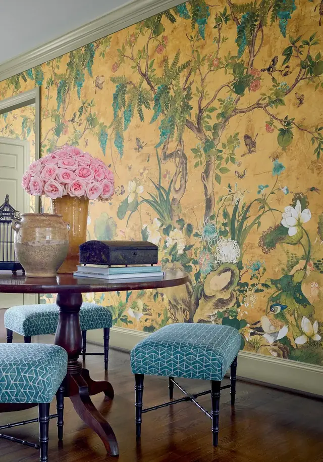 Ochre panoramic Chinoiserie mural with birds and flowering wisteria in a traditional room