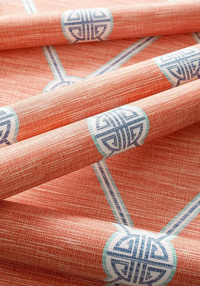 Coral trellis wallpaper rolls showing printed colour, raised texture and pattern scale