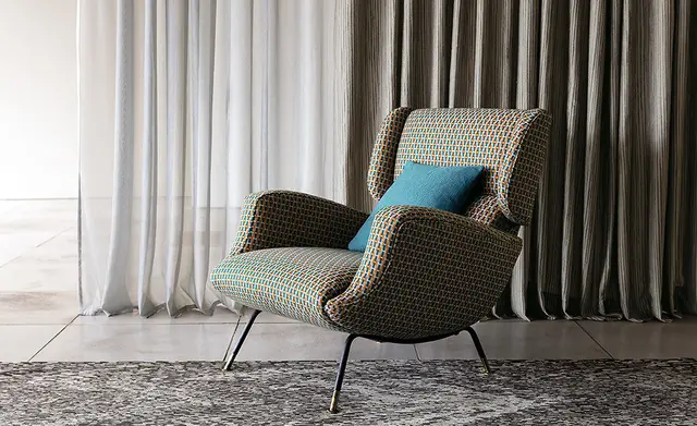 Contemporary chair and full-length curtains upholstered in coordinating Trevira fabrics