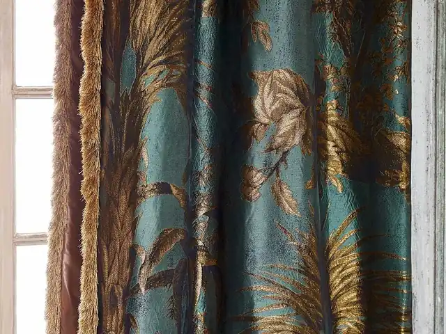 Deep blue-green curtain fabric with gold-coloured leaf motifs and fringe