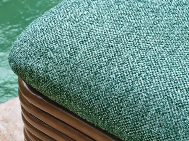 Close-up of turquoise woven upholstery on a curved rattan seat
