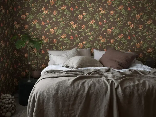 Dark vintage floral wallpaper in a softly styled bedroom