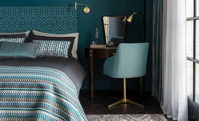 Coordinated washable curtain, upholstery and bedding fabrics in a contemporary bedroom