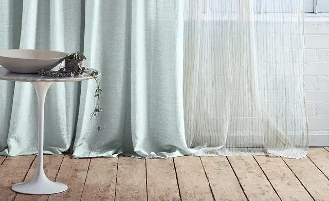 Room-high sheer and wide-width curtain fabrics displayed at full drop
