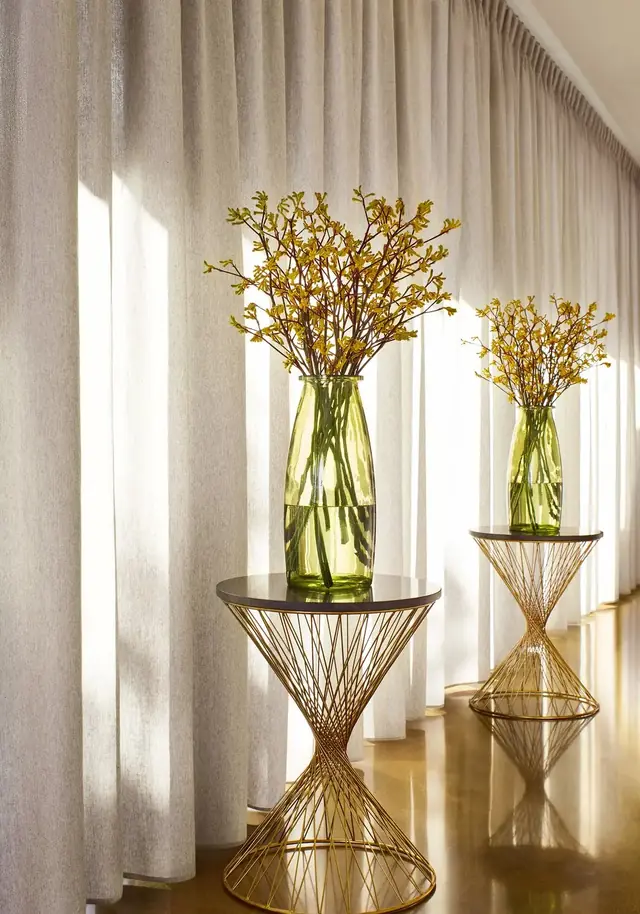 Wide-width voile curtain fabric hanging in soft full-height folds
