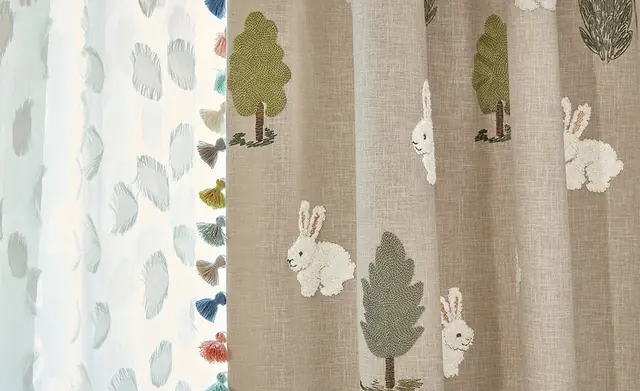Close view of woodland children's curtain fabrics with trees, rabbits and deer