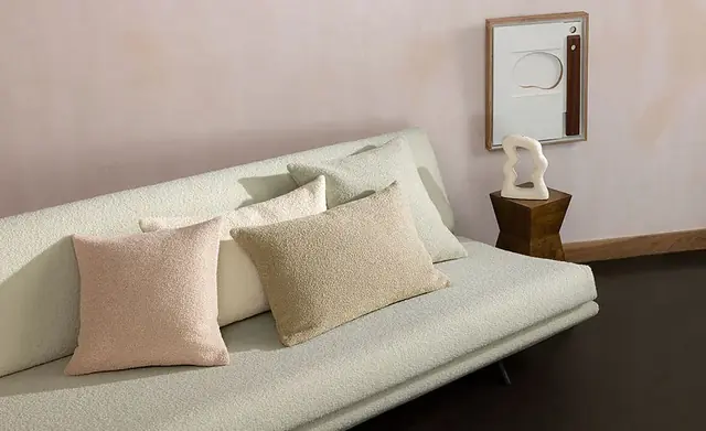 Cream bouclé upholstery fabric on a contemporary sofa and cushions