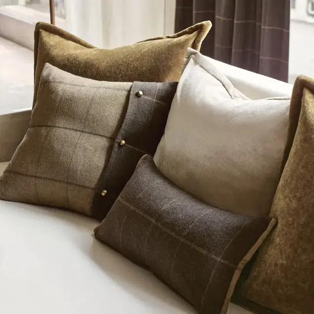 Coordinating checked and plain wool fabric cushions in warm neutral colours