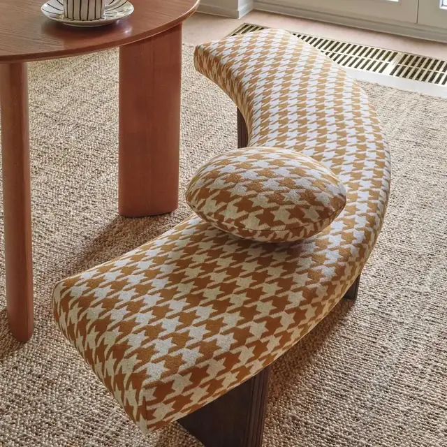 Woven geometric upholstery on a curved bench and round cushion