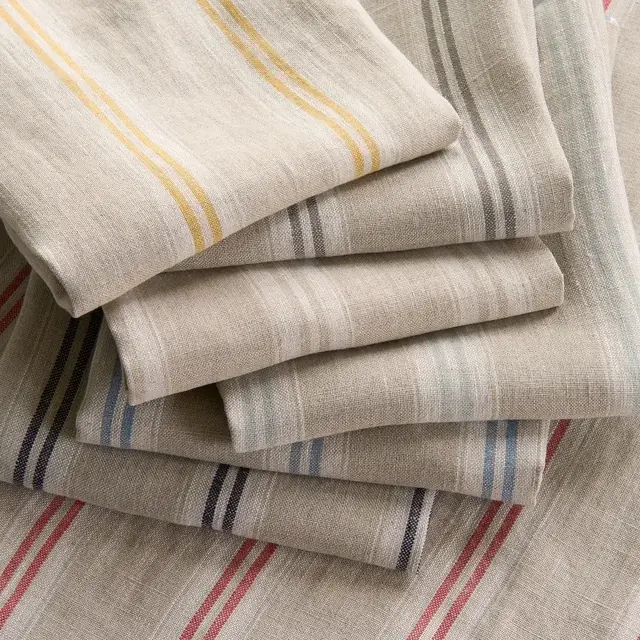 Selection of natural woven striped fabrics in blue, red, yellow and grey