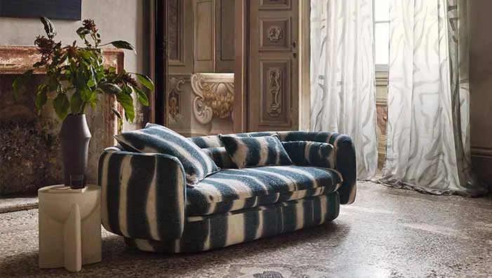 A stylish sofa covered in royal blue and navy blue upholstery fabric, creating a modern yet comfortable look. Includes royal blue velvet upholstery fabric.