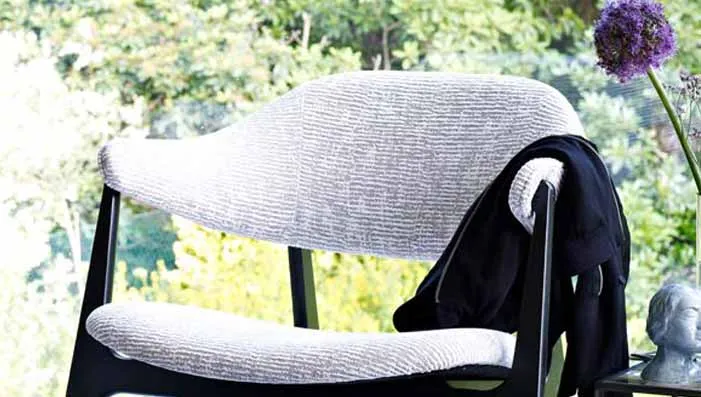 Chenille fabric cushions on a sofa, emphasizing the plush texture and comfort of the material.
