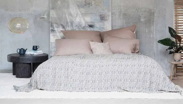 A close-up of cotton fabric used for bedding, highlighting its softness and breathability, perfect for a comfortable sleep.