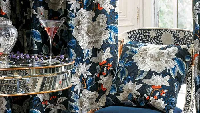 A detailed image of fabric with intricate embroidery patterns, highlighting the craftsmanship and colorful threadwork.