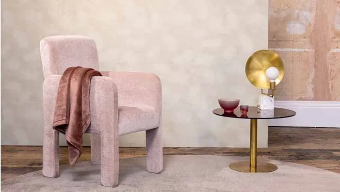 A soft and elegant pink upholstered chair, offering a touch of sophistication. Perfect for blush pink upholstery fabric.